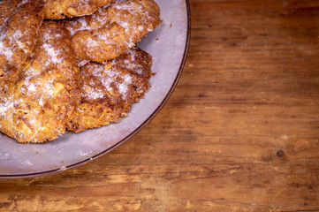 Homemade cookies in a plate on a wooden background