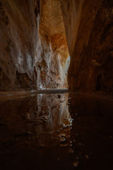 Reflection from a puddle at the bottom of an ancient water reservoir in Zippori Park, Israel