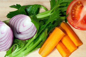 colorful vegetables on a wooden background. Onion, tomato, carrots, celery. simple food. healthy food. Vitamines