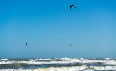 Kitessurfer flying under the sea .A person surfing and parachuting at the same time in Vietnam.