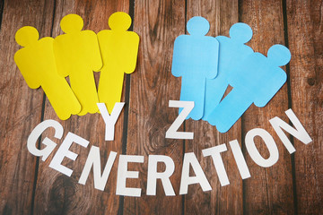 x and y generation symbol, paper models of people of different nationalities on wooden background