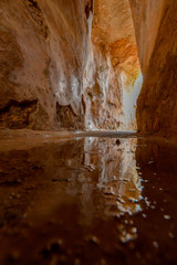Reflection from a puddle at the bottom of an ancient water reservoir in Zippori Park, Israel