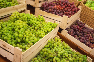 Green grapes in a wooden box on a store counter, selective focus. Creative trade, decoration solutions. Gardener, Farming.