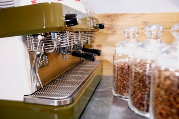 hot coffee and coffee beans on the background of coffee grinders