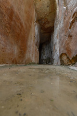 Reflection from a puddle at the bottom of an ancient water reservoir in Zippori Park, Israel