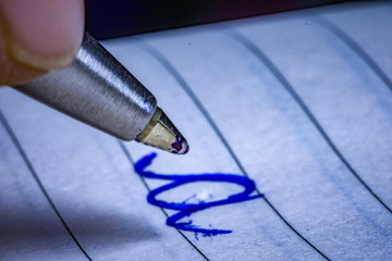 pen in hand writing cursive