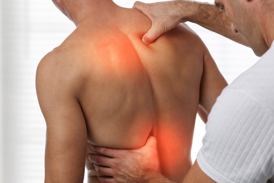 Acupressure, back pain relief concept. Male patient Physiotherapy, Injury Rehabilitation treatment - Powered by Adobe
