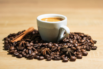 A cup of coffee with heart pattern in a white cup on wooden background
