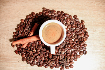 A cup of coffee with heart pattern in a white cup on wooden background