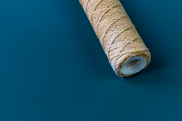 A water filter whose cartridge needs to be replaced. Question mark. Close-up. On a wooden...