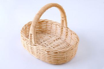 Small wicker from a vine basket for gifts on a gray background