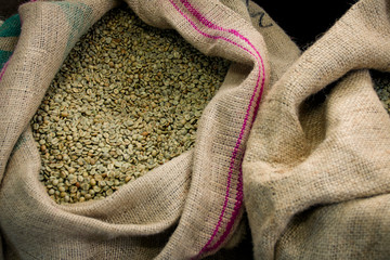 Green coffee beans in a jute bag