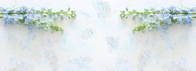 spring bouquet of blue flowers over white vintage wooden background. top view, flat lay