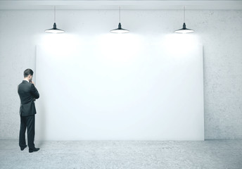 Fototapeta premium Businessman looking on blank banner