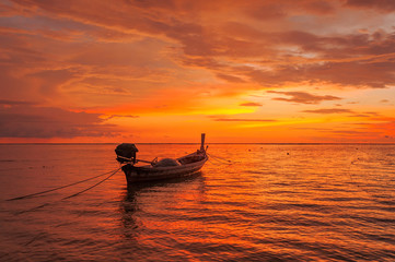 Boat near beach at sunset