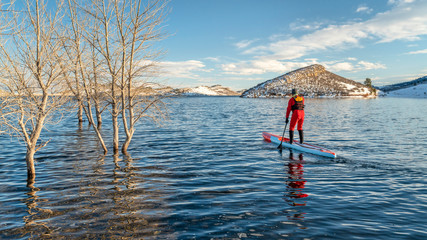 paddling stand up paddleboard in winter
