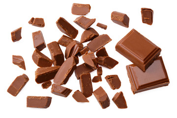 milk chocolate broken into pieces isolated on a white background. top view
