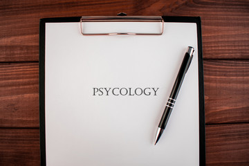 Word psycology: text written on a shit of paper of notebook on the wooden background. Medical concept.