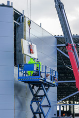 Obraz premium sandwich panels wall mounting using crane and scissor lift