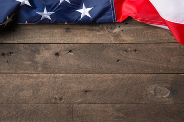 American flag lying on old wooden background