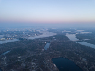 Aerial drone view. Sunrise over the Dnieper in Kiev. On the horizon is a river and bridges.