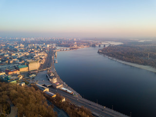 Fototapeta na wymiar Aerial drone view. View of the Dnieper River and the Podil district in Kiev in the early morning.