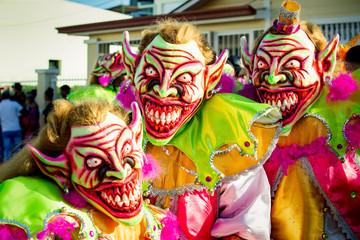 closeup three men in scary clowns costumes pose for photo at dominican carnival - obrazy, fototapety, plakaty