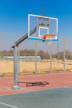 The transparent basketball board front of fence