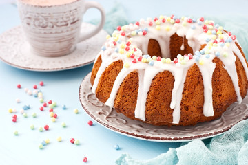 Cocoa mug and homemade cake round form with icing