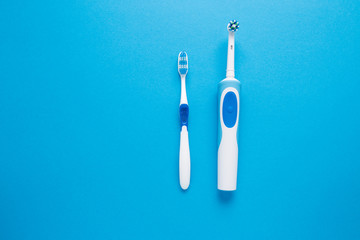 Electric or simple toothbrush on a blue background.