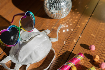 Party with mask protection in croud of people. Concept, close-up. Place for text.