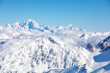 Fototapeta na wymiar Val Thorens, France - February 18, 2020: Winter Alps landscape from ski resort Val Thorens. Mont Blanc is the highest mountain in the Alps and the highest in Europe