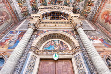Obraz premium Wide low angle view of the colorful frescoed portal leading to the medieval cathedral of Aosta