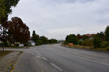 Road intersection through populated place. Autumn landscape