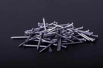 Construction nails on a workshop table. Macro photography.