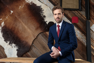 attractive young businessman fixing shirt in a coffeeshop