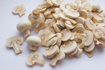 Raw fresh cut mushrooms at white background of the table