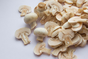Raw fresh cut mushrooms at white background of the table