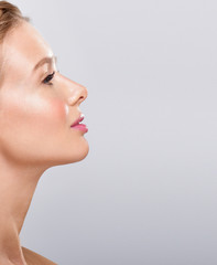 Beautiful face of young adult woman with clean fresh skin.