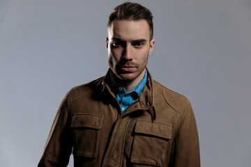 Confident fashion model looking forward while wearing leather jacket