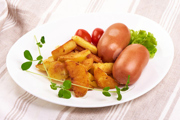 Fresh boiled sausages with baked potatoes, isolated on white background