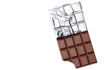 bitten milk chocolate bar in foil isolated on white background. top view