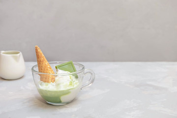 Obraz na płótnie Canvas Matcha affogato recipe with vanilla ice cream and healthy matcha green tea in a glass cup on grey background
