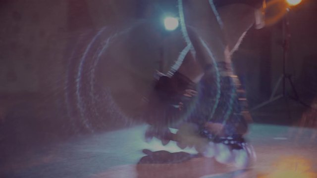 A young man demonstrates excellent technique on roller skates. Underground location, fashionable light, youth, trendy. Shot on a red camera.