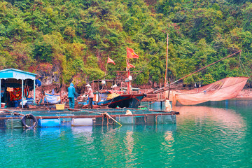 Boat near floating fishing village in Ha Long Bay Asia © Roman Babakin