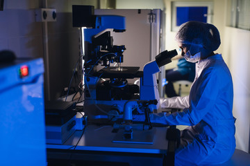 In a Modern Laboratory Scientist Conduct Experiments. The embryologist Examines Samples with a Microscope