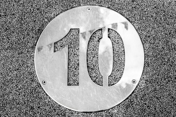 Number Ten, Abstract black and white image of a road surface with the number ten. 