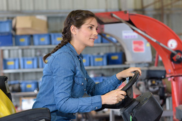 a woman driving a tractor