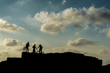 Fototapeta premium Mallorca, Spain, October 1st 2016: Shadow of three xtreme ciclysts on the rocks with blue sky background.