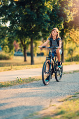 Fototapeta na wymiar Girl Riding Her Bike To School